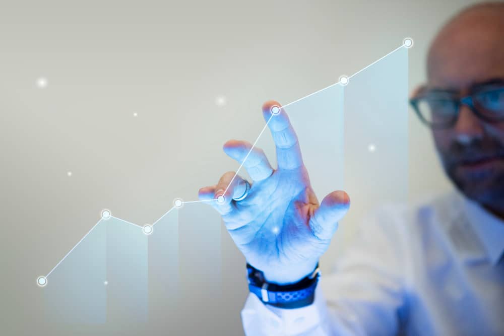 businessman pointing his finger to growth graph